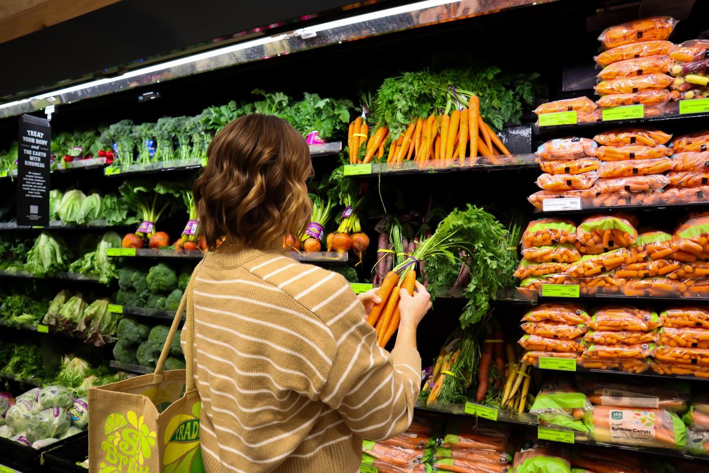 Shopper choosing fresh vegetables at a local grocer Shopper choosing fresh vegetables at a local grocer